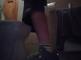 Sporty guy peeing at home